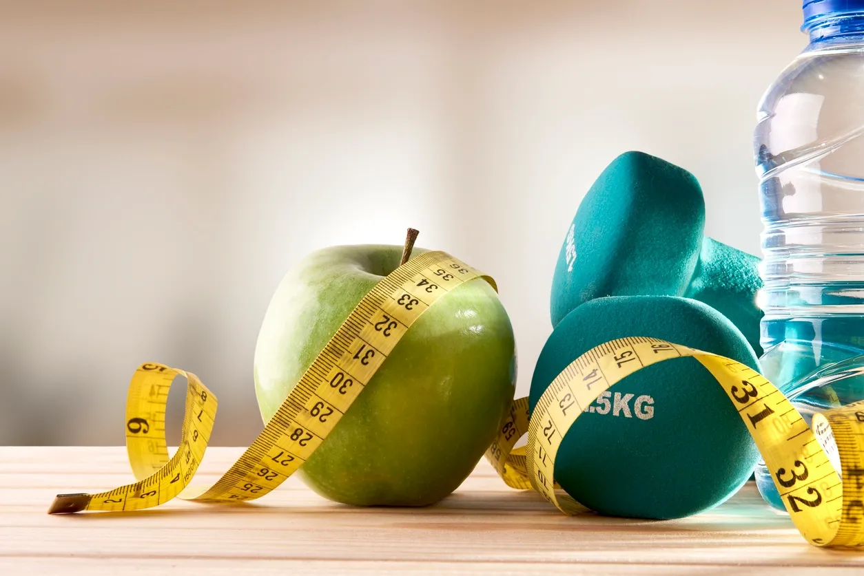 Green apple with measurement tape